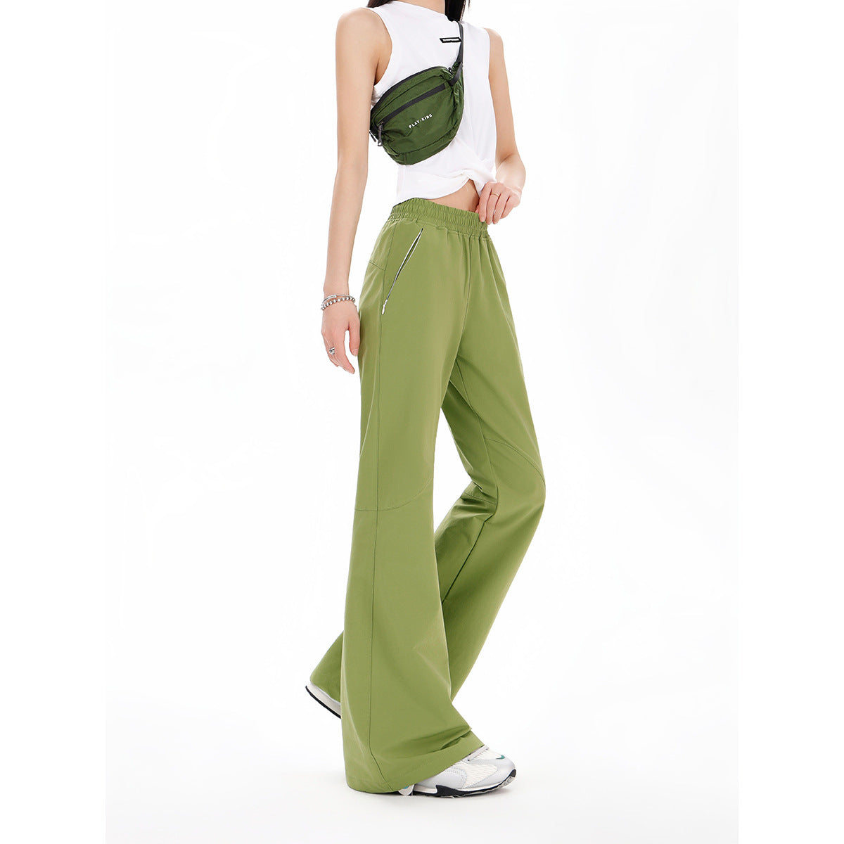 Model wearing olive-green wide-leg pants with an elastic waist and angled zip pockets.