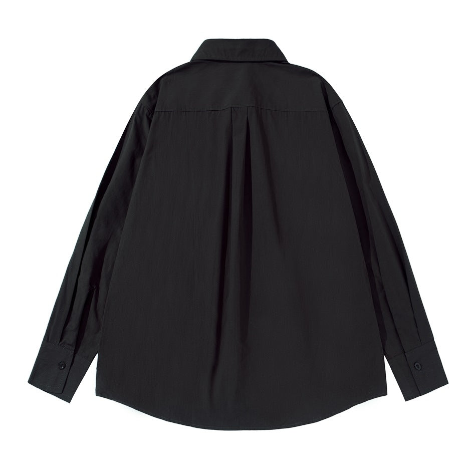 Back view of a black long-sleeved button-up shirt laid flat, showing a yoke seam and center pleat.