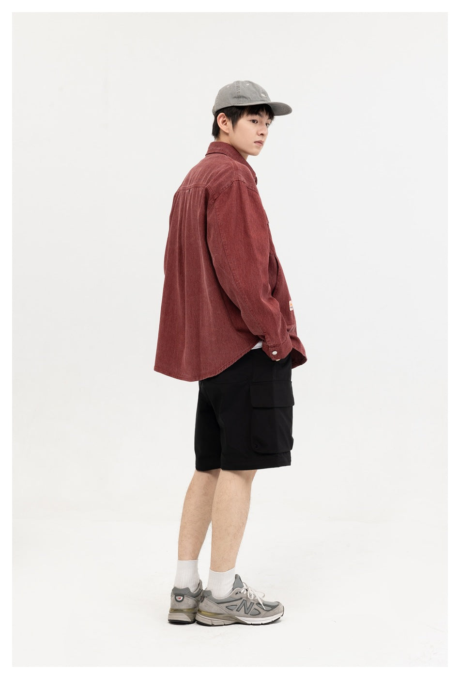 Model in a burgundy button-front shirt, shown from a side and partial back angle.