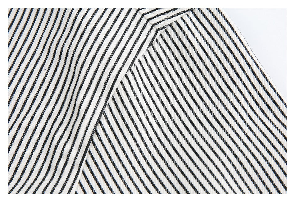Close-up of a seam joining two sections of black-and-white striped fabric.