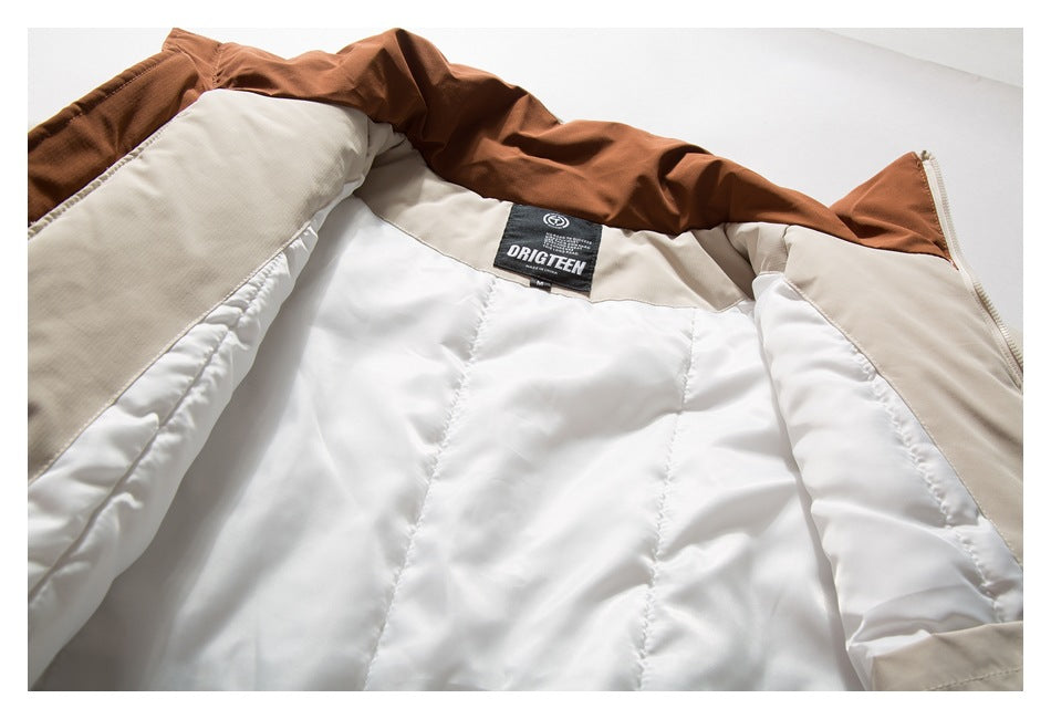 Close-up of a jacket's white quilted lining, tan panels, brown collar lining and sewn-in neck label.
