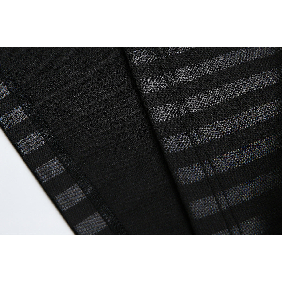 Close-up of the inside seam and striped black fabric of a garment.
