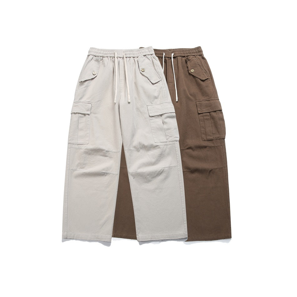 Two loose cargo pants displayed together in light gray and brown, with drawstring waists and flap pockets.