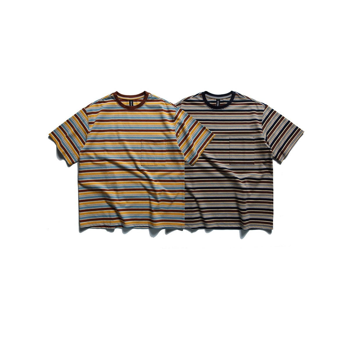 Two short-sleeve striped crew-neck T-shirts shown from the front, one in mustard and blue and one in dark neutrals; both have