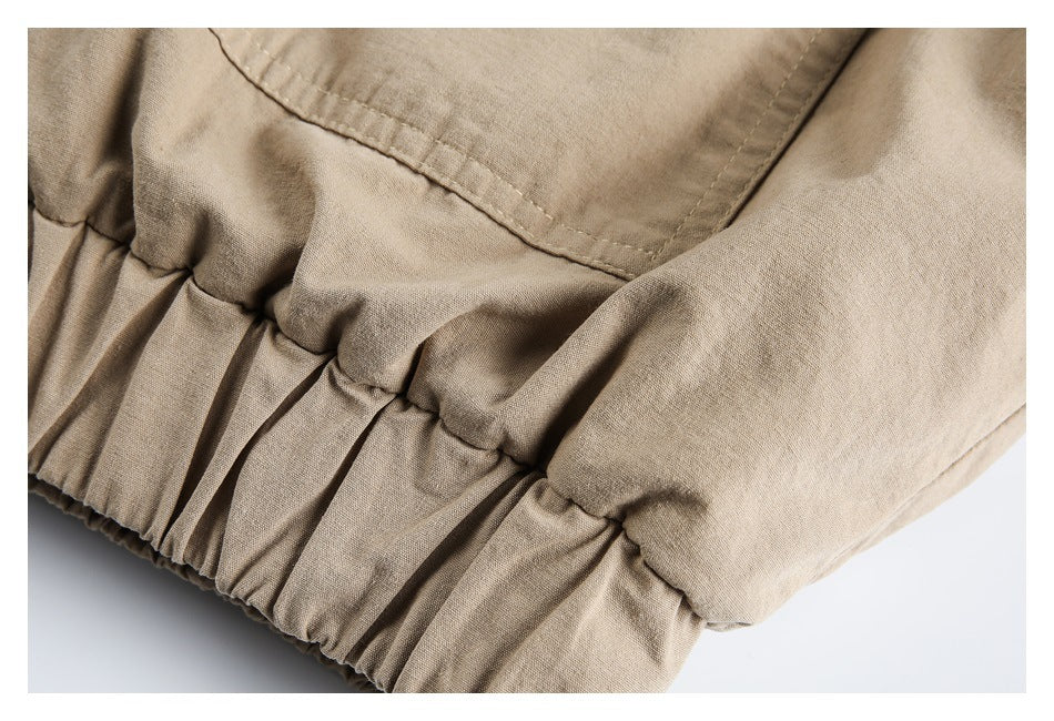 Close-up of a beige garment with a gathered elastic edge and stitched panel.