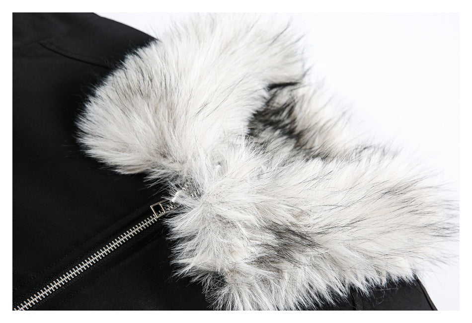 Close-up of a black jacket with a silver zipper and thick gray-white faux-fur hood trim.