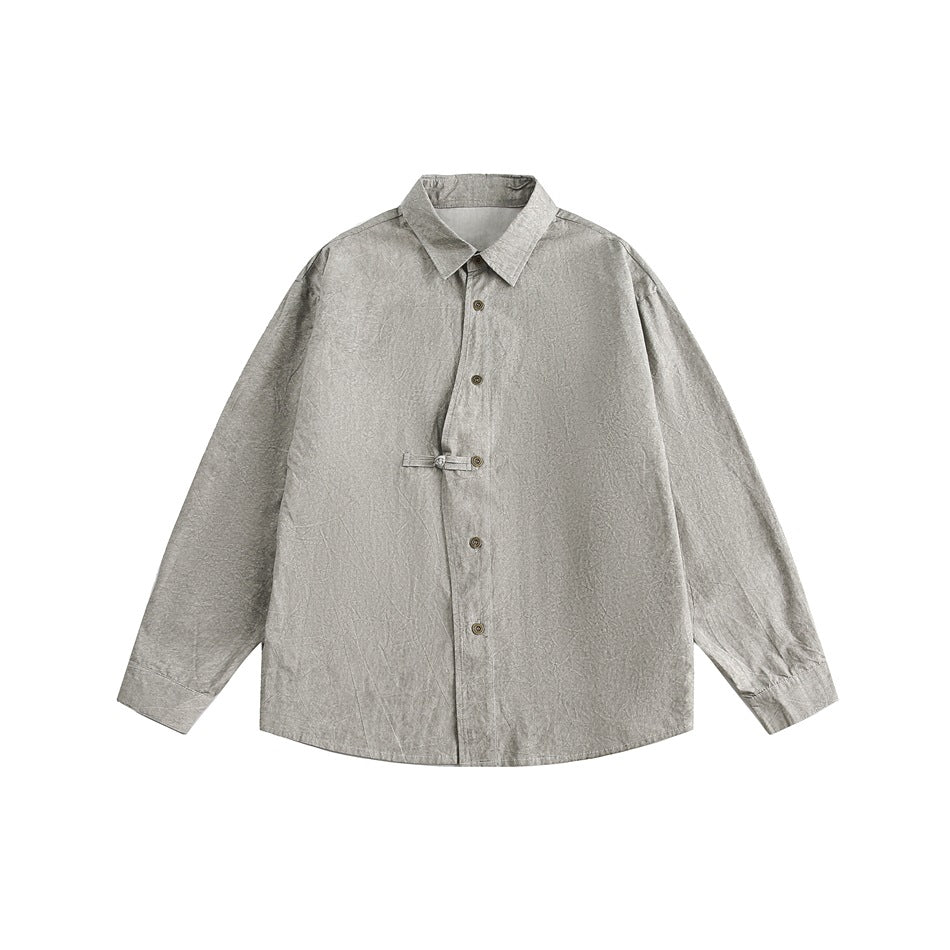 Front view of a light gray long-sleeve button-up shirt with a pointed collar and a small fastening tab at the waist.