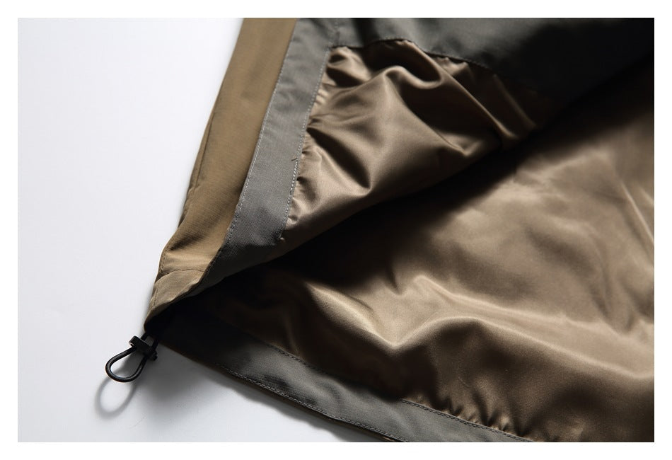 Close-up of the jacket's brown interior lining, gray edge trim and a small black hem loop.