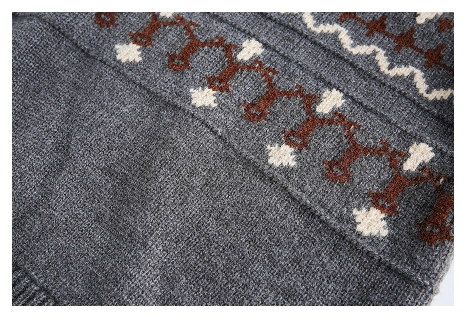 Close-up of gray knit with a rust and cream patterned band beside a plain panel.