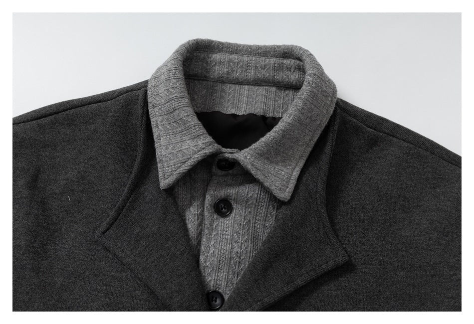 Close-up of the charcoal jacket's gray ribbed collar, layered lapels and black front buttons.