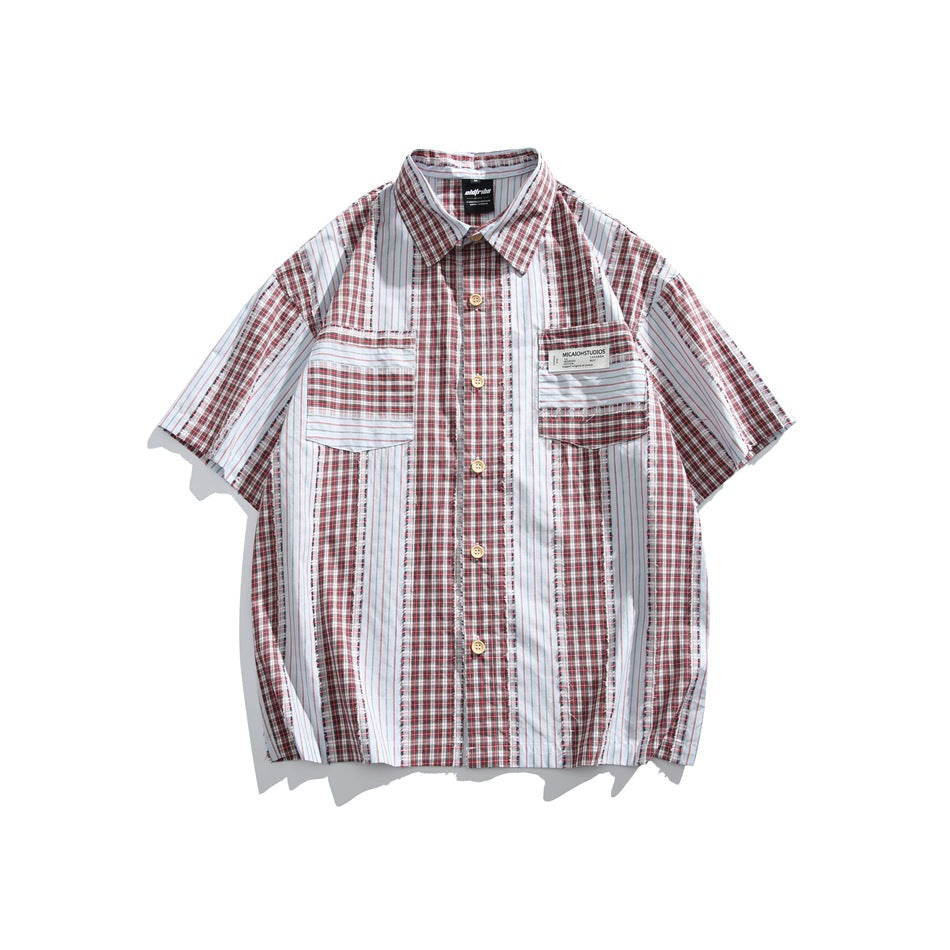 Red plaid and white pinstripe short-sleeve button-up shirt with two chest flap pockets, flat lay front view