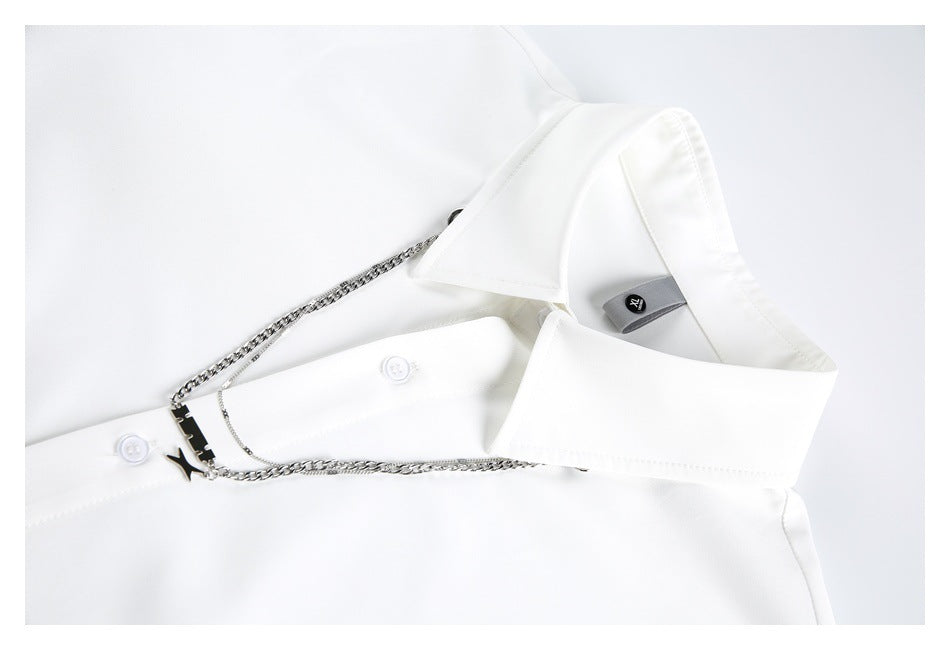 Close-up of a white shirt collar, button placket and silver chain accessory.