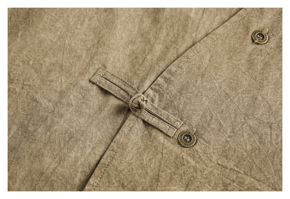 Close-up of a khaki-brown shirt's knotted fabric-loop closure and round buttons.