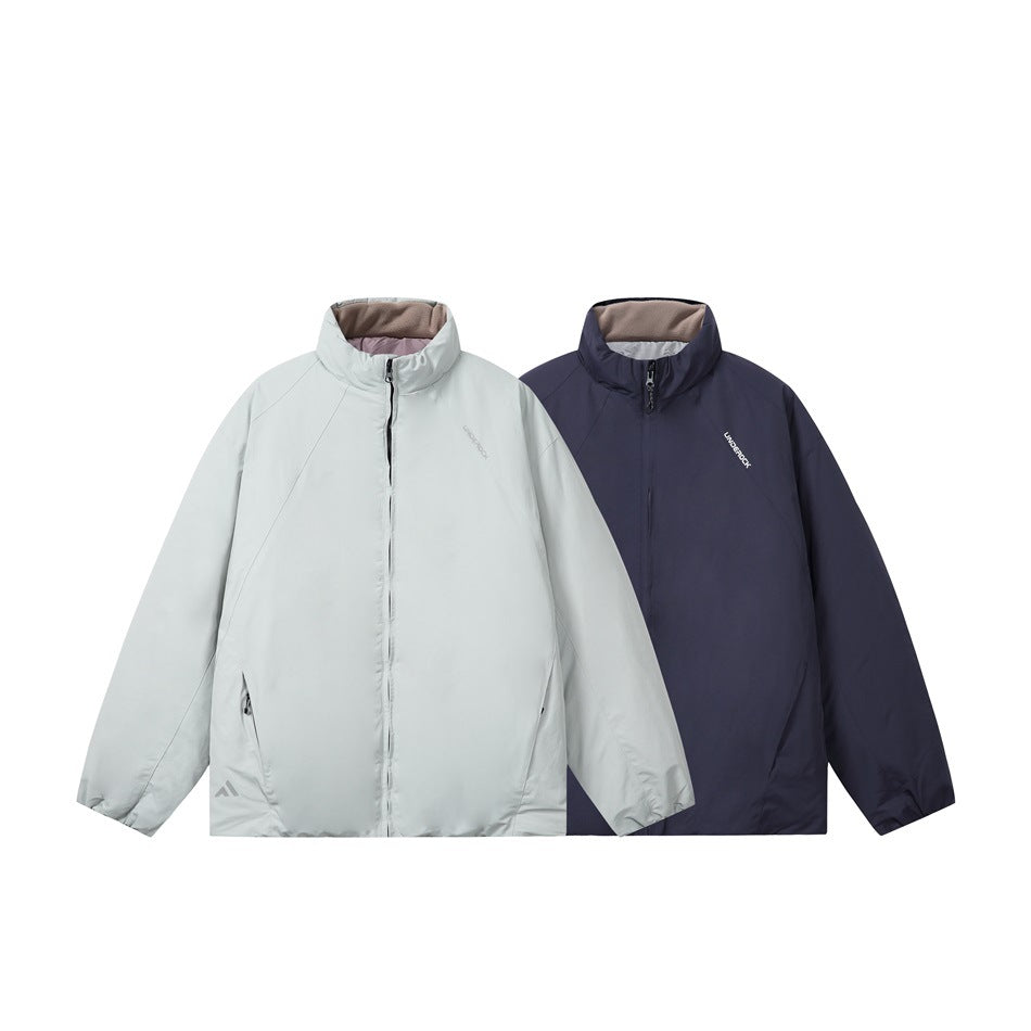 Two front-view jackets shown together in pale gray and dark navy, both with stand collars and full zippers.