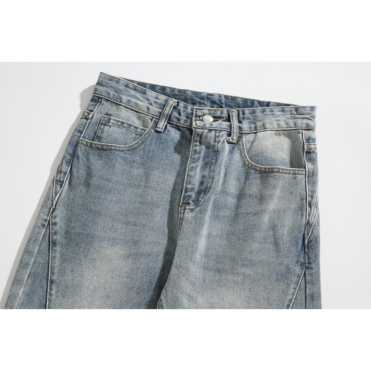 Close-up of the front waistband and pockets of light-wash blue jeans with contrast stitching.