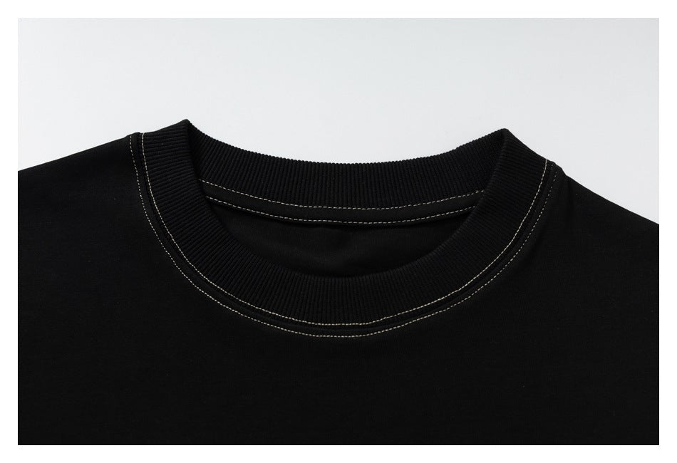 Close-up of a black T-shirt's ribbed crew neck with contrasting double stitching.