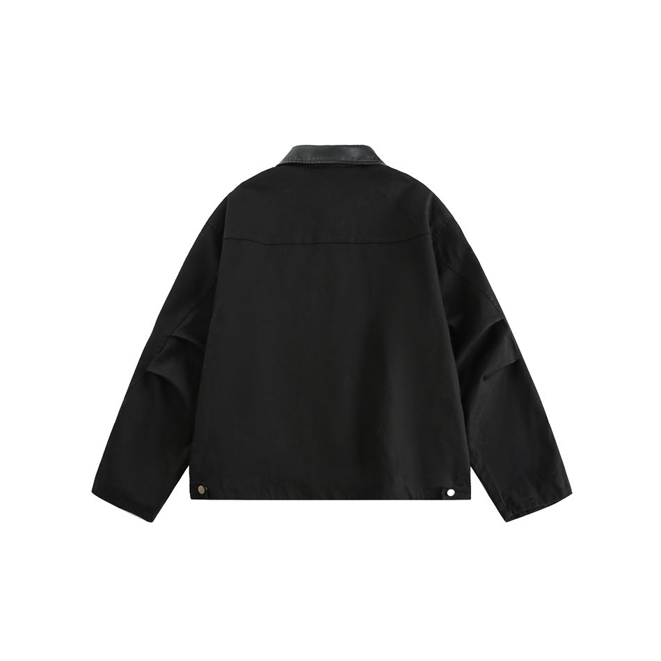 Back view of a black jacket with long sleeves, a dark contrast collar and snap details at the hem.