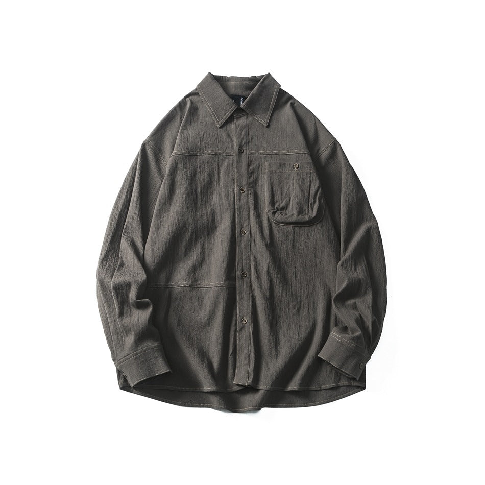 Gray-green long-sleeve button-up shirt flat lay with chest pocket, contrast stitching and pointed collar