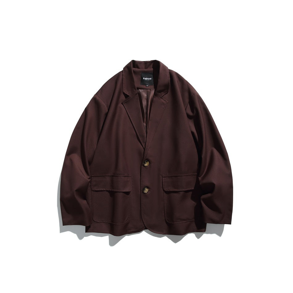 Front view of a dark brown blazer with notch lapels, two buttons and two large flap pockets.