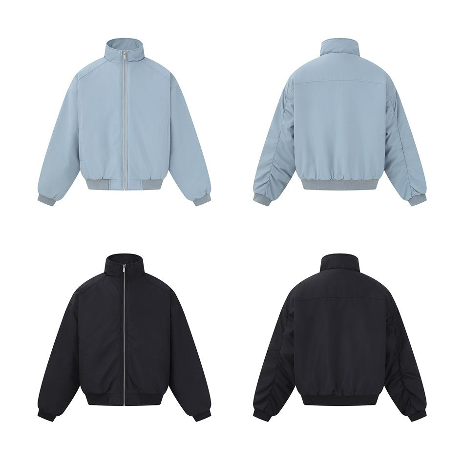 Front and back views of the gray-blue and black zip jackets, showing ruched back sleeves and yoke seam