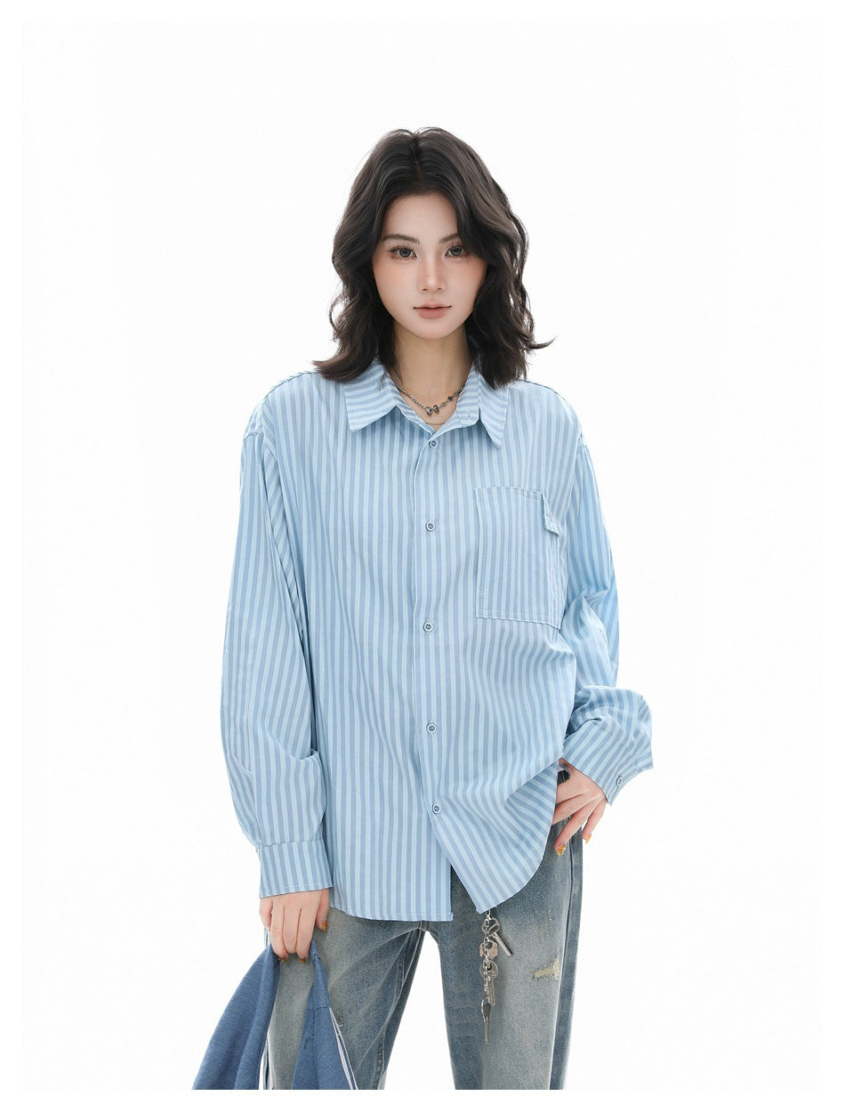 Model wearing a loose light blue and white striped button-up shirt with a chest pocket.