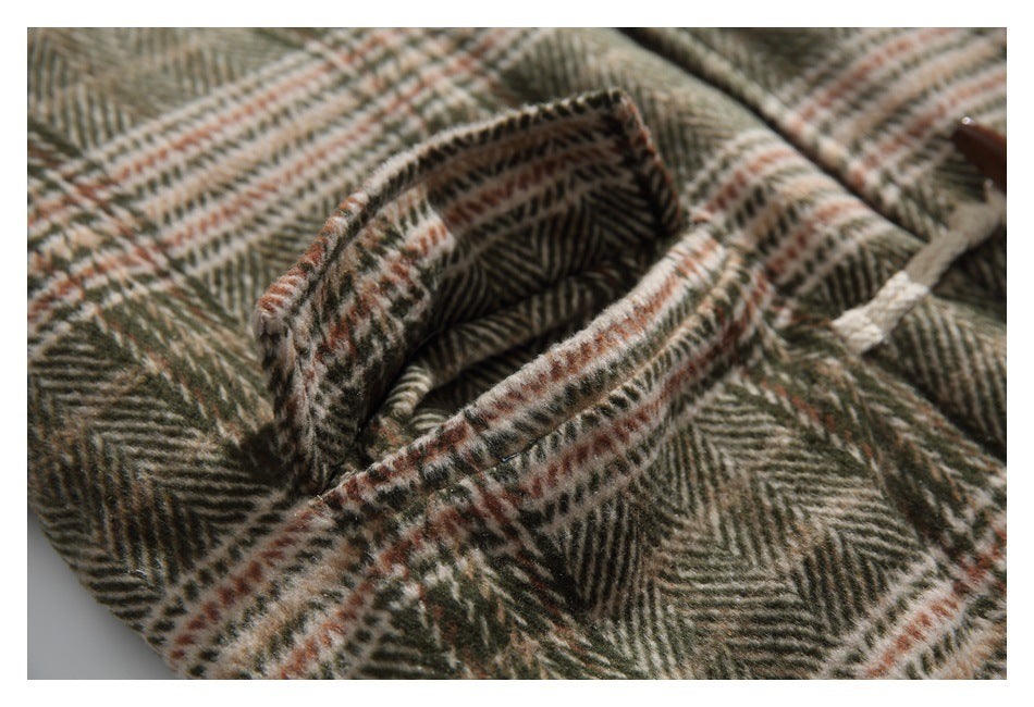 Close-up of a folded collar on a brown, olive, and cream herringbone plaid garment.