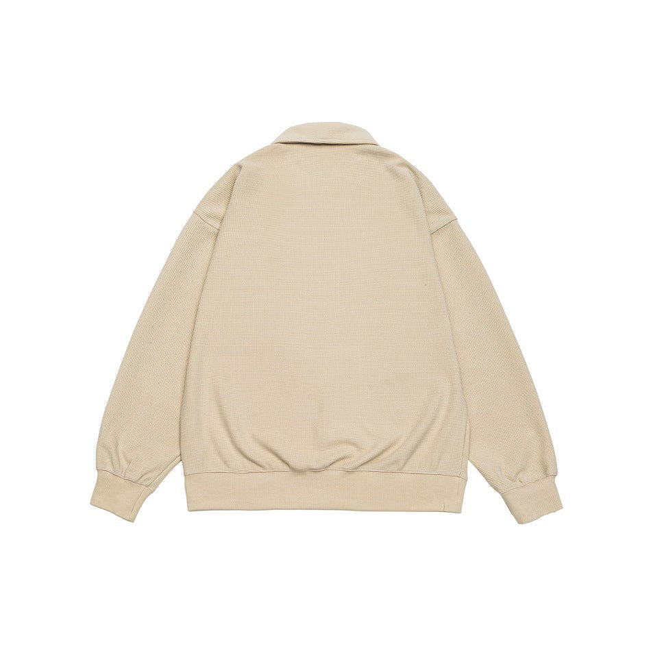 Back view of a beige collared knit jacket with long sleeves, ribbed cuffs, and a ribbed hem.