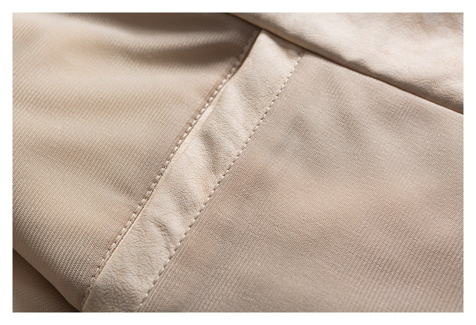 Close-up of beige garment construction showing a textured inner panel beside a stitched strip.