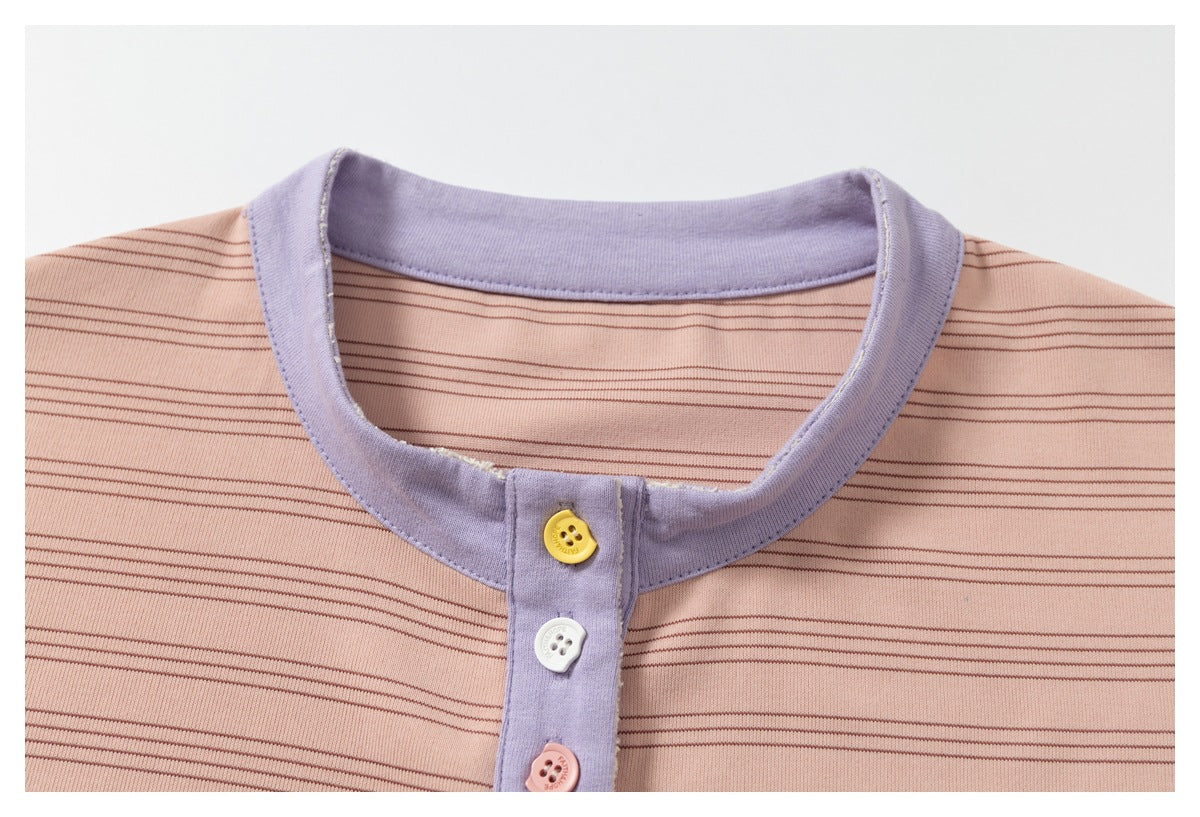 Close-up of a lavender collar and button placket on a peach-pink shirt with fine dark stripes.
