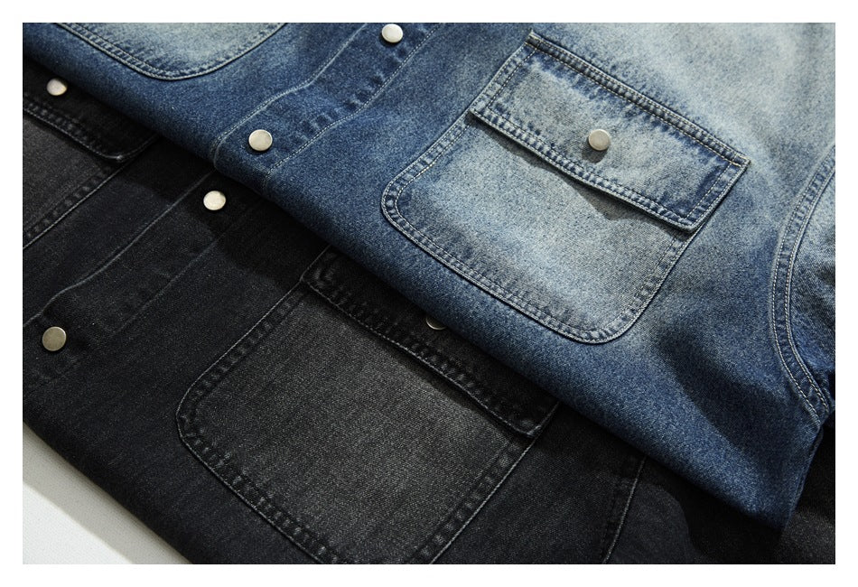Close view of blue and black denim shirts with snap buttons and flap chest pockets.