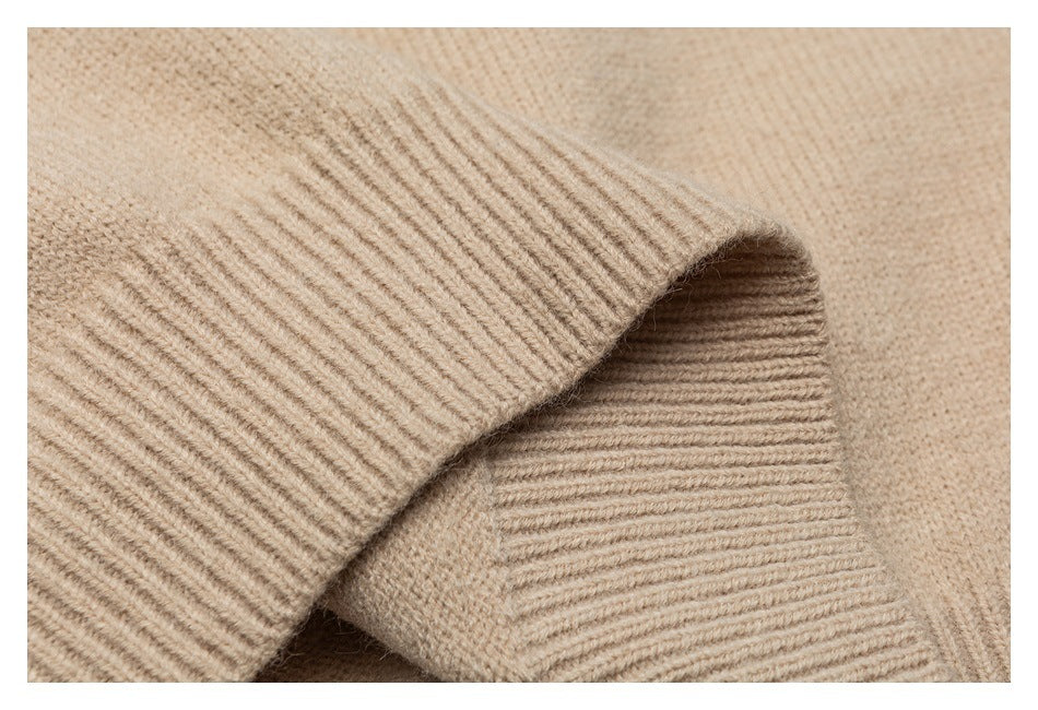 Close-up of the beige sweater's folded ribbed knit edge.
