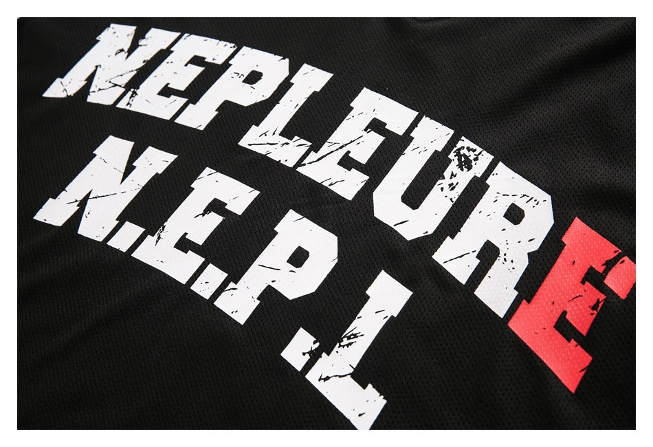 Close-up of distressed white and red lettering printed across the front of a black mesh jersey.