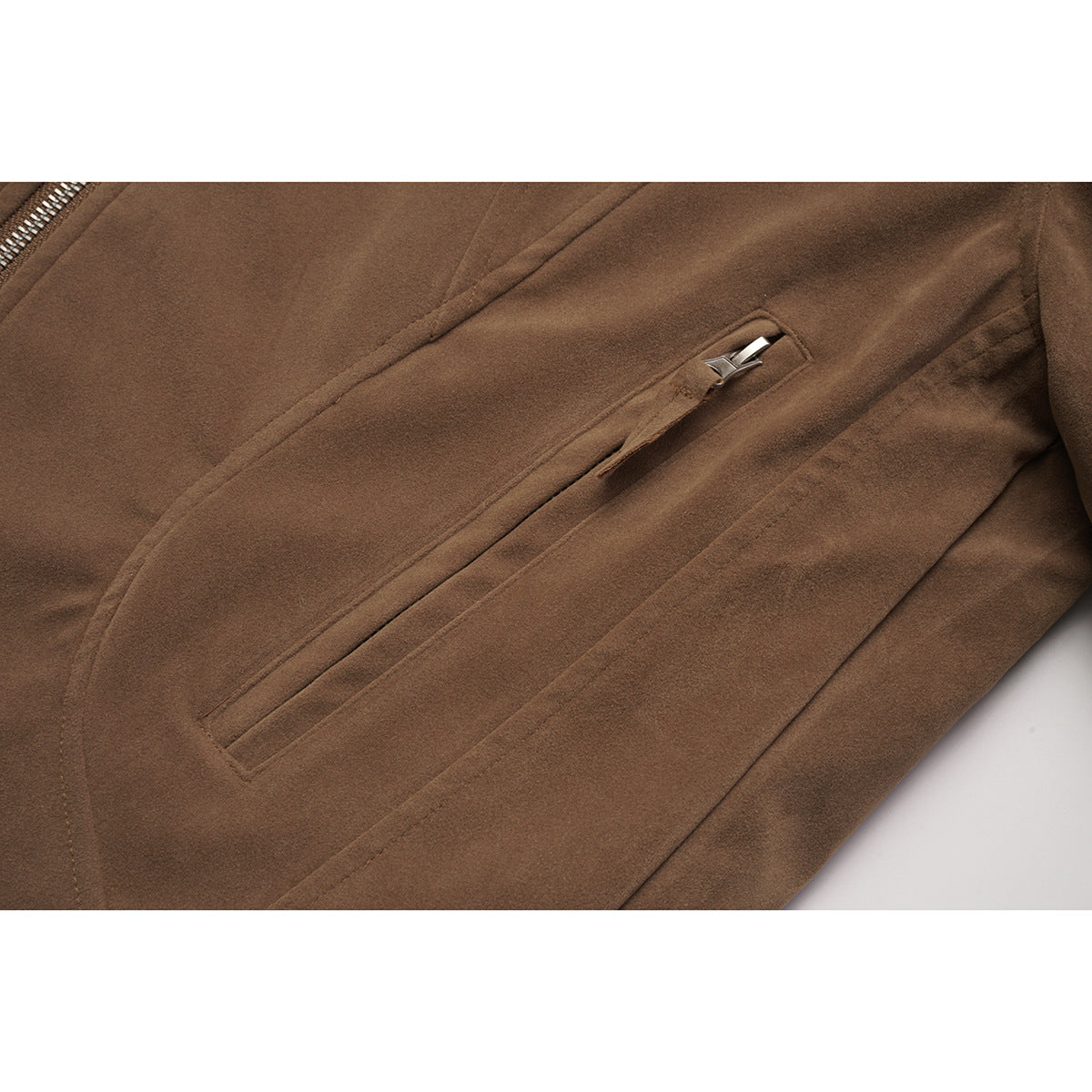 Close-up of a brown jacket's slanted zip pocket and stitched panels.