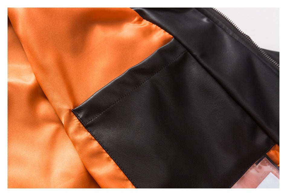 Close-up of an orange garment lining with a large black stitched panel and zipper edge.