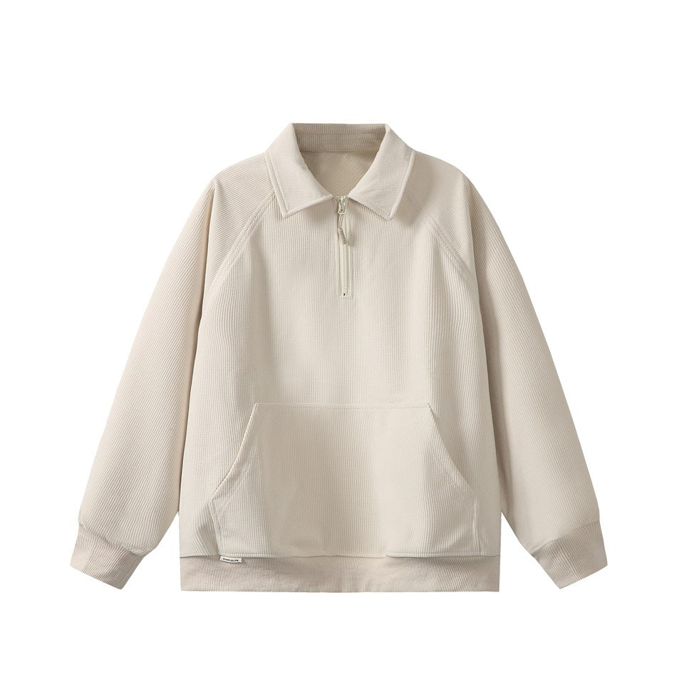 Apricot waffle-knit quarter-zip sweatshirt with polo collar, raglan sleeves and front pocket, flat lay