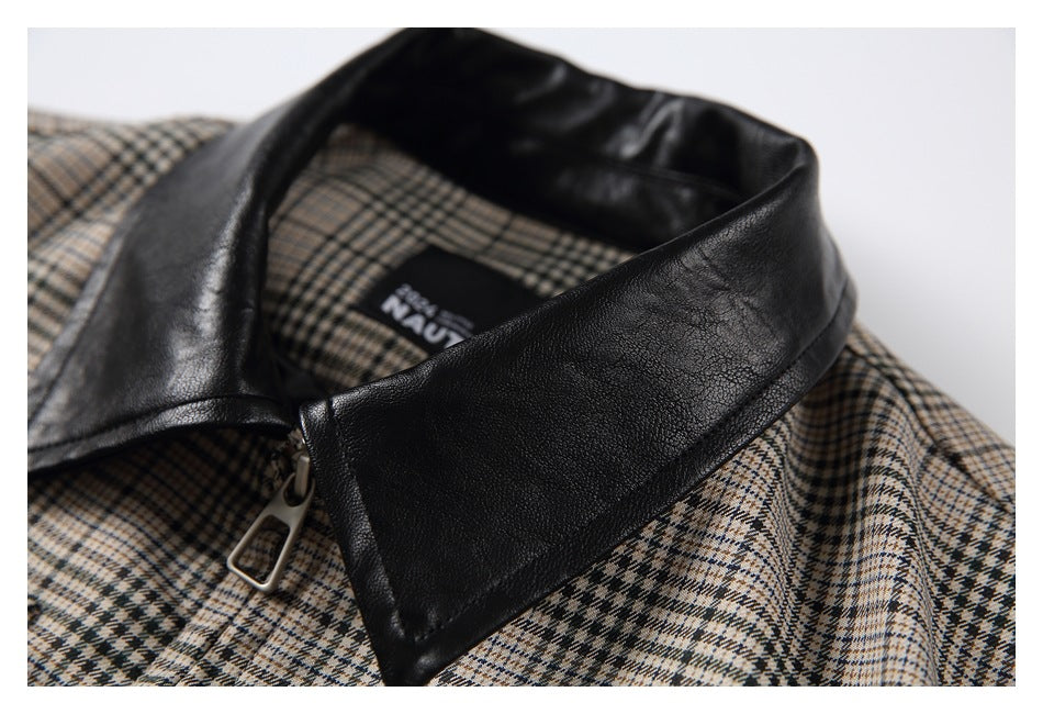 Angled close-up of the black collar and zipper pull against the beige and dark plaid shirt.