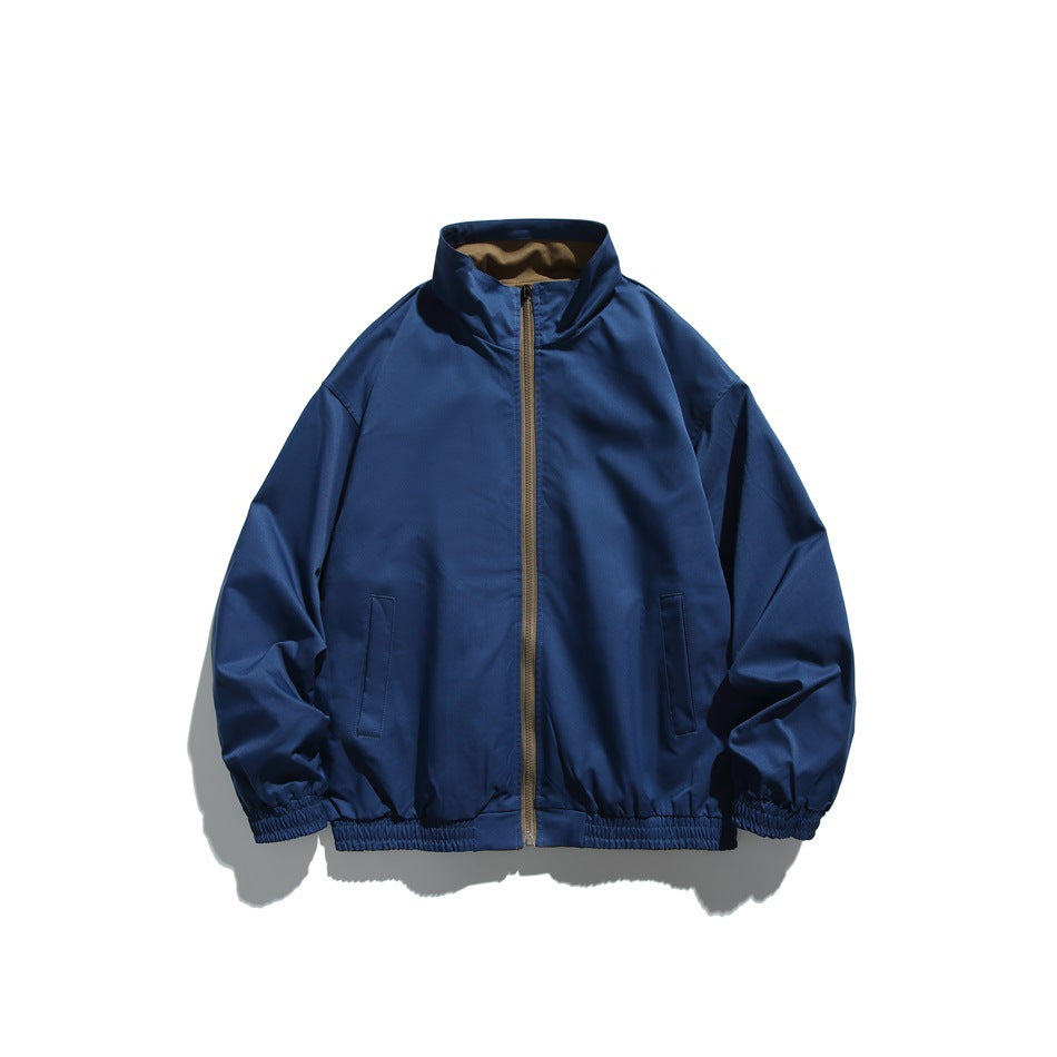 Blue zip-front jacket with a contrasting brown zipper and collar lining, stand collar, hand pockets, and elastic cuffs and