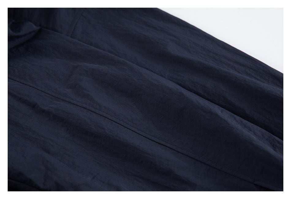 Close-up of a stitched seam on dark navy garment fabric.