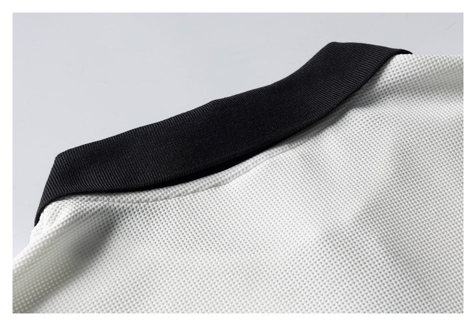 Close-up of a white textured garment with a wide black ribbed collar.