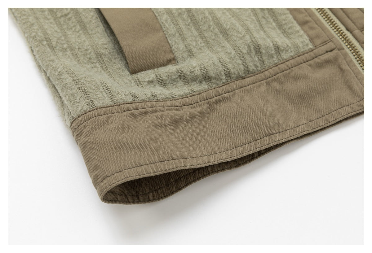 Close-up of the taupe jacket hem, showing a wide stitched border and striped panel.