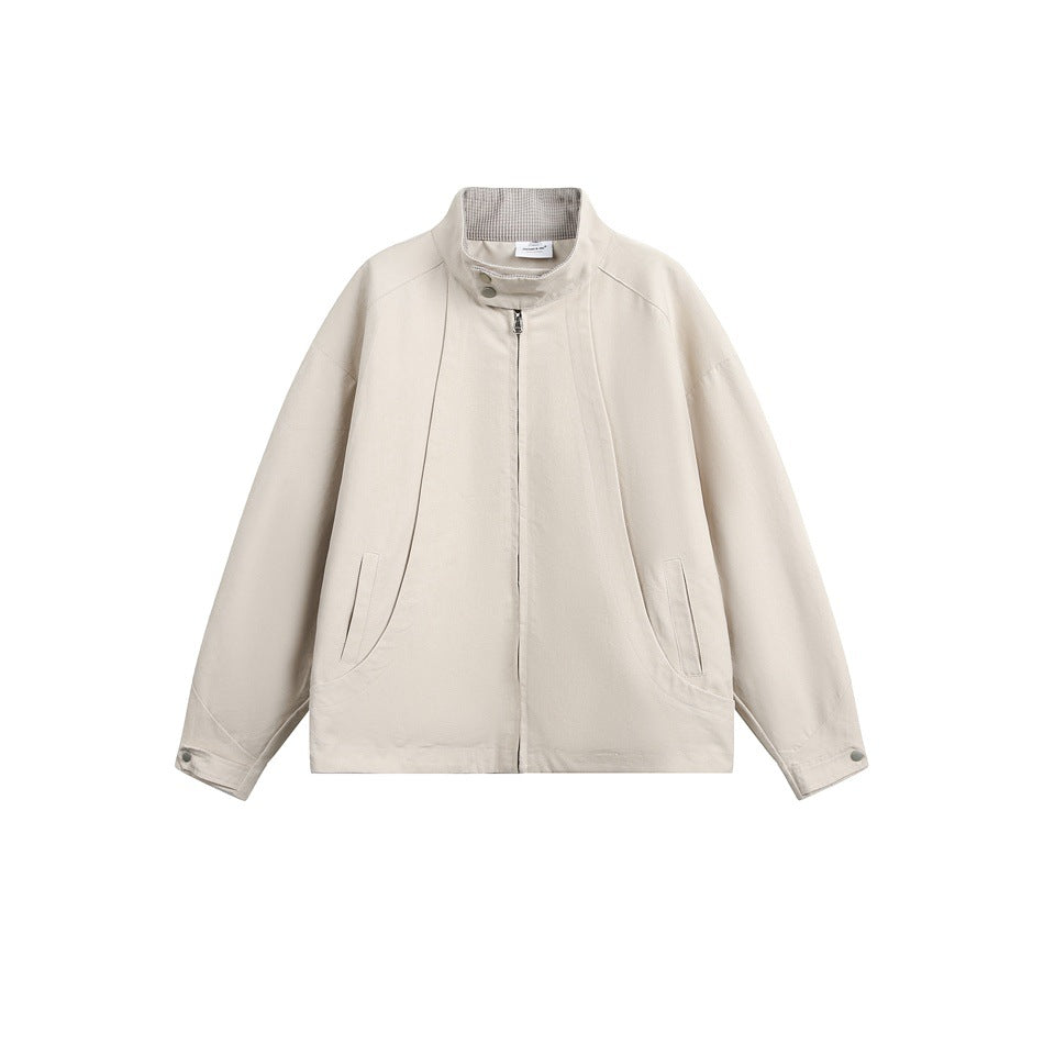 Beige stand-collar zip jacket flat lay, front view with curved seams, slanted pockets and snap cuffs