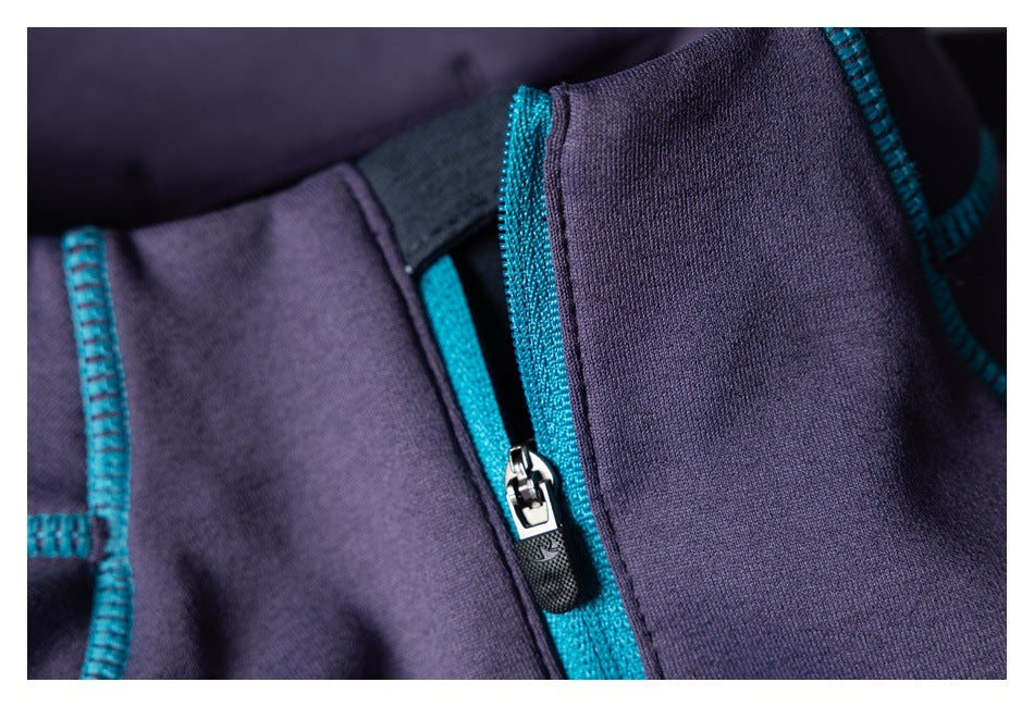 Close-up of a zipper with teal trim on a dark purple garment.