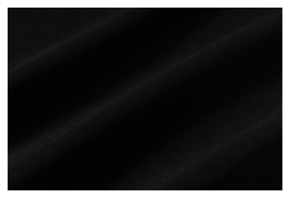 Extreme close-up showing the texture of black T-shirt fabric.