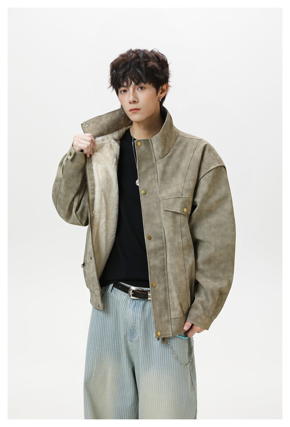 Model opens the taupe jacket to show its light-colored plush lining, front zipper, stand collar, and brass-tone buttons.