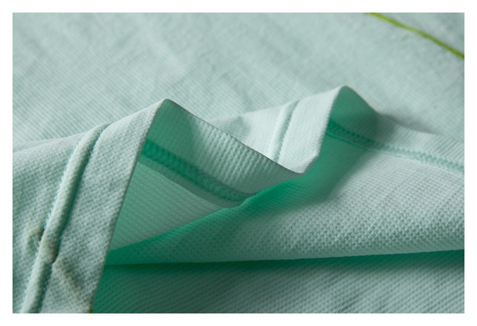 Close-up of a pale mint garment collar and textured knit fabric.