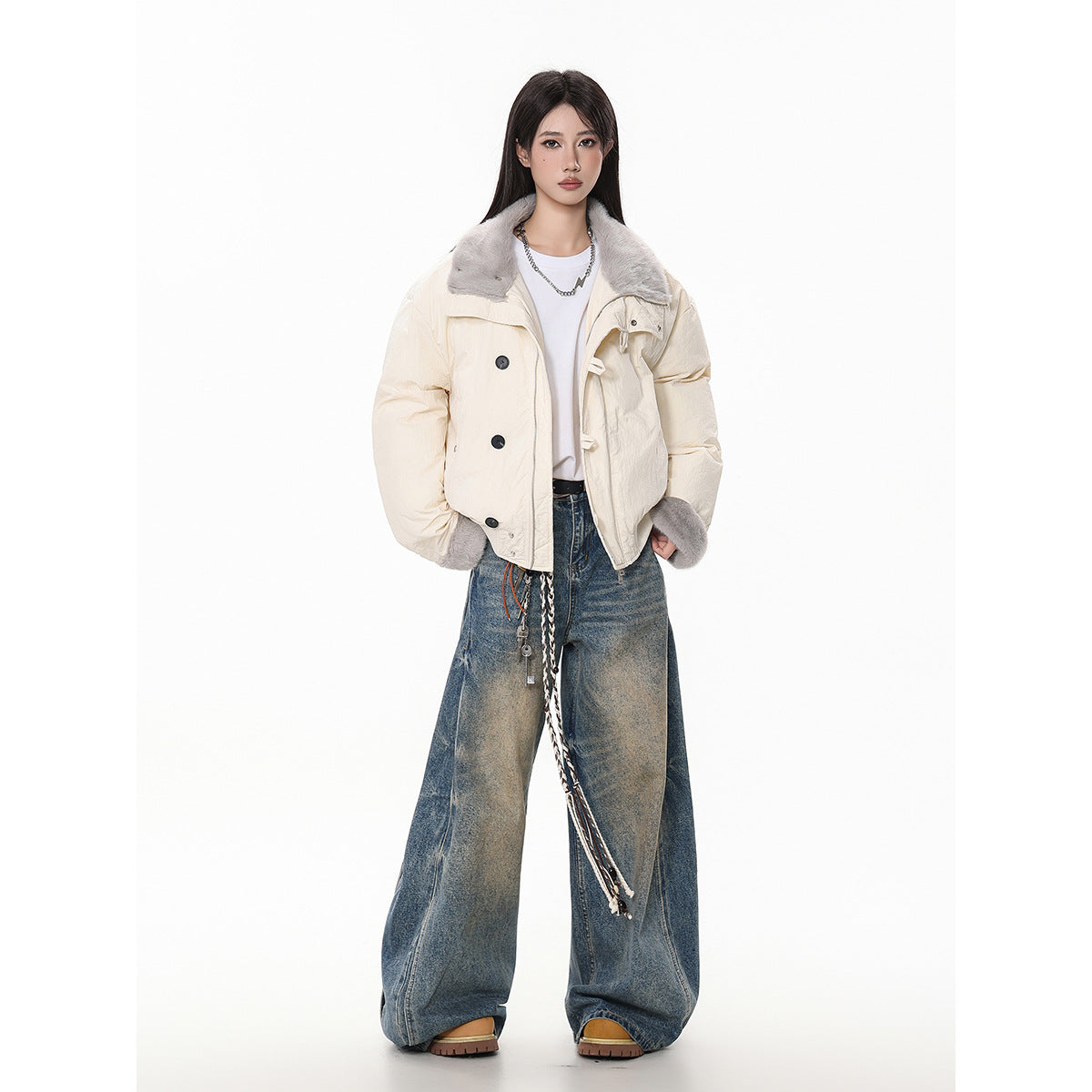 Model wearing an ivory cropped jacket with a gray faux-fur collar and cuffs, styled with wide-leg blue jeans.