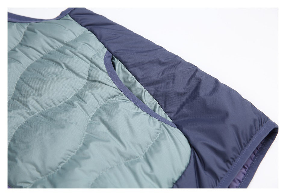 Close-up of a curved bound opening between blue-gray quilted fabric and a navy panel.