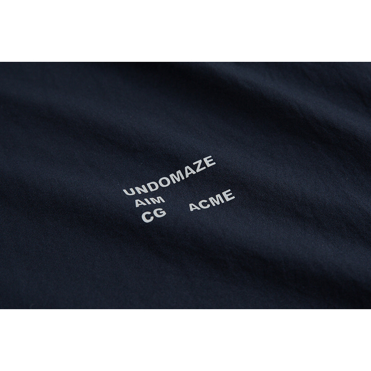 Close-up of dark navy fabric with white text printed on it.