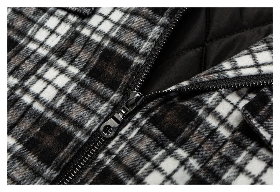 Close-up of a black-and-white plaid garment with a black zipper and quilted black lining.