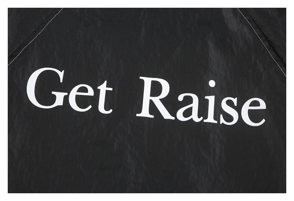 Close-up of white “Get Raise” lettering printed on the black jacket.